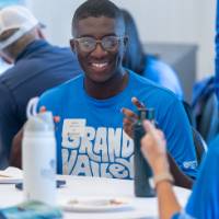Gentleman smiling at woman he is talking with at table